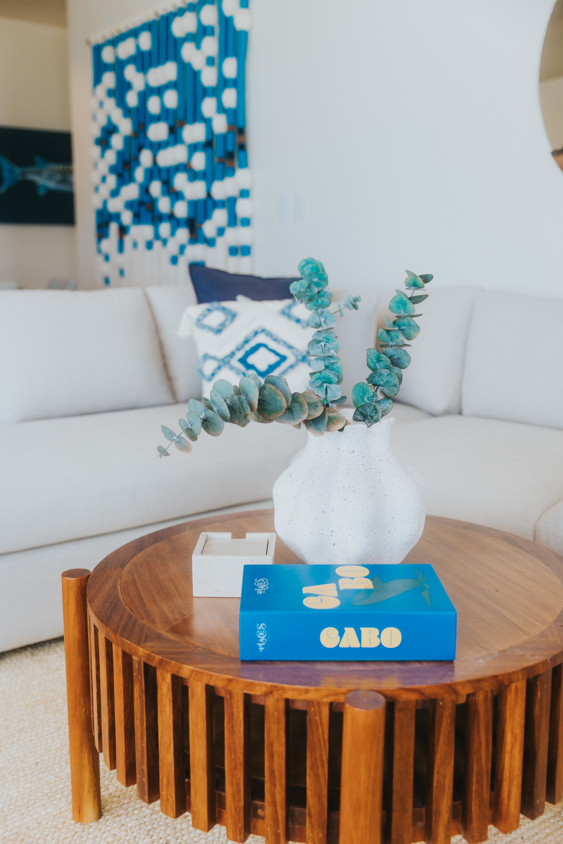 Living room with woven wall art and artisan coffee table