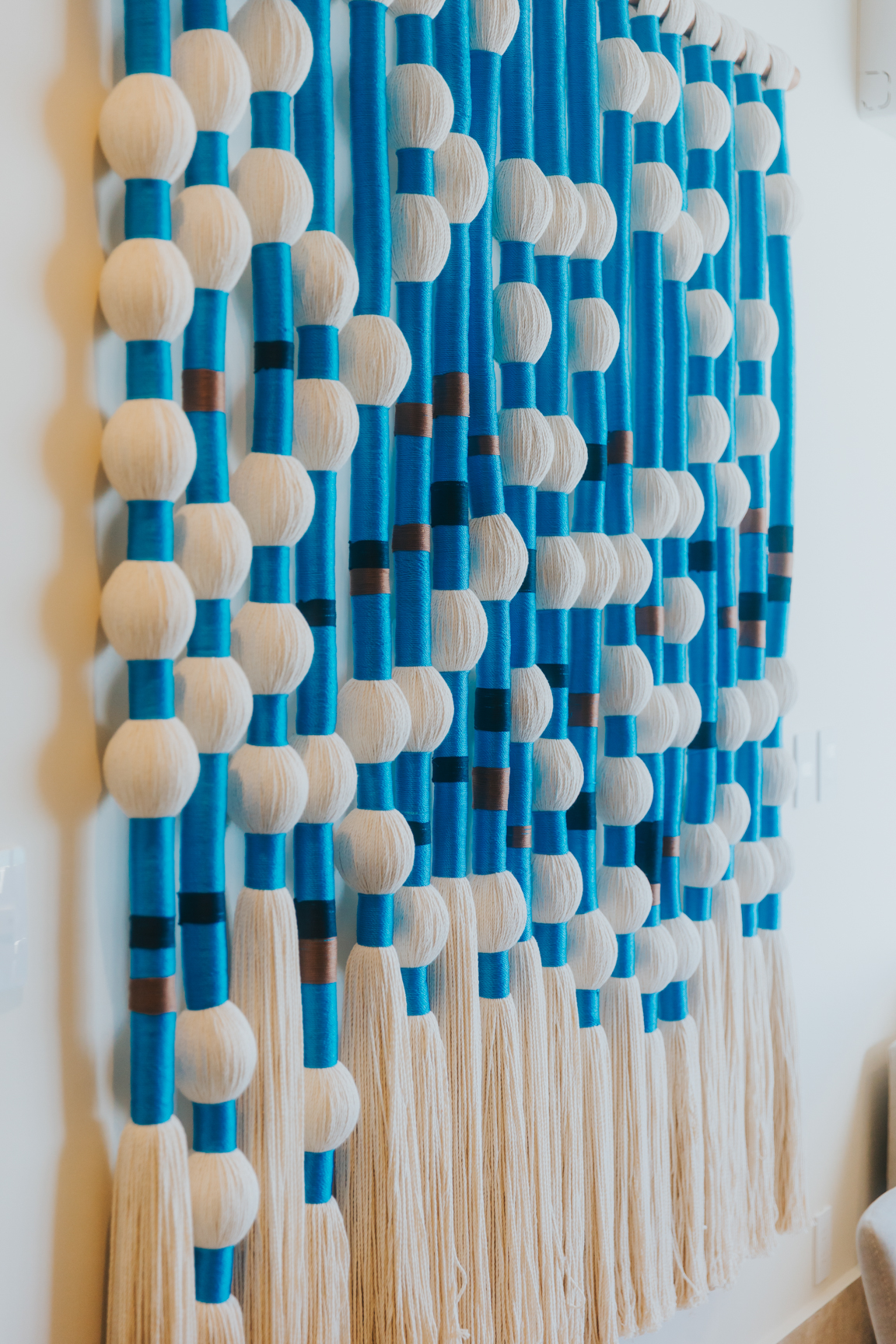 Handwoven blue and ivory textile wall art by Mexican artisans
