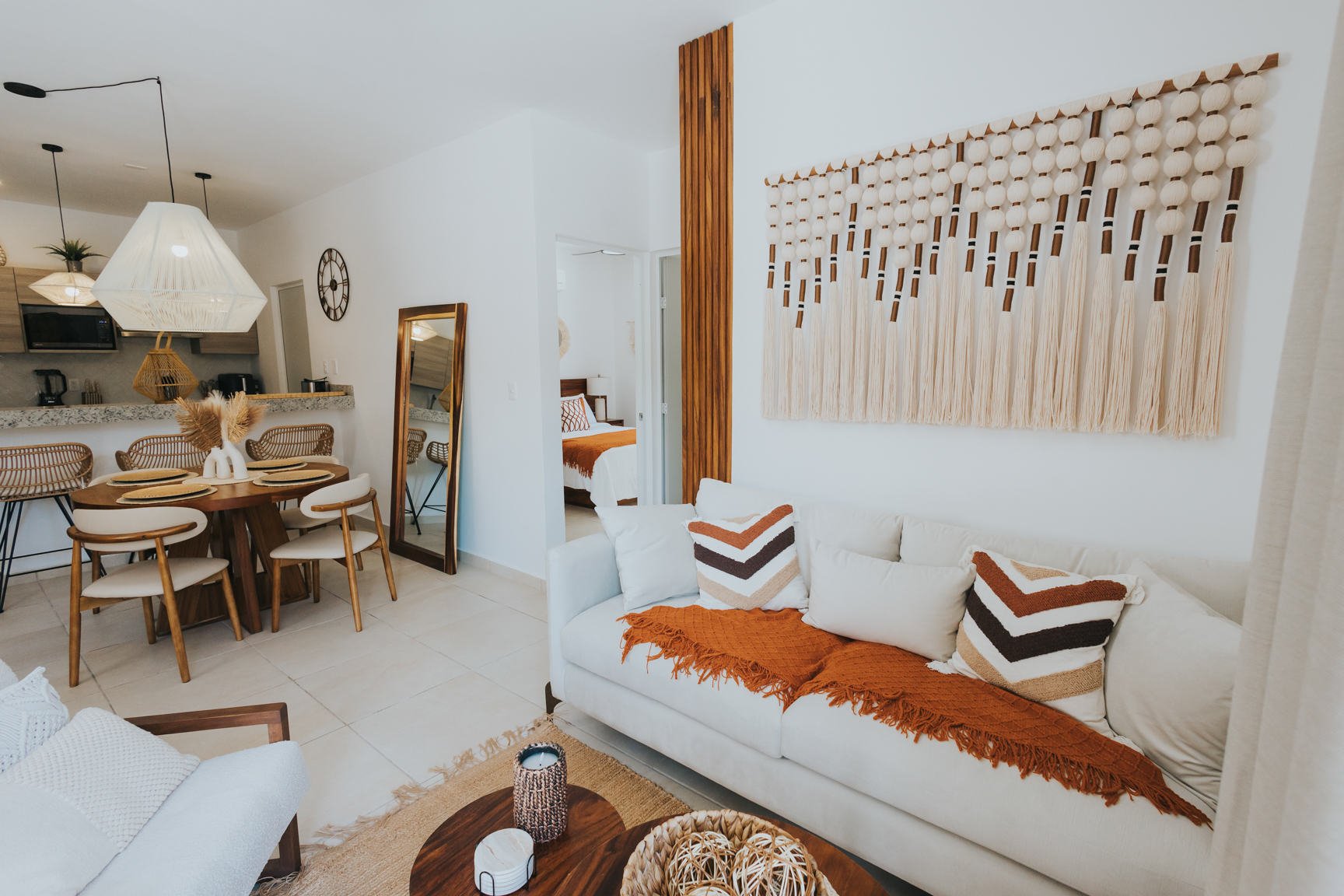 Casa del Sol open living room with cream sofa, terracotta throw and macramé wall art