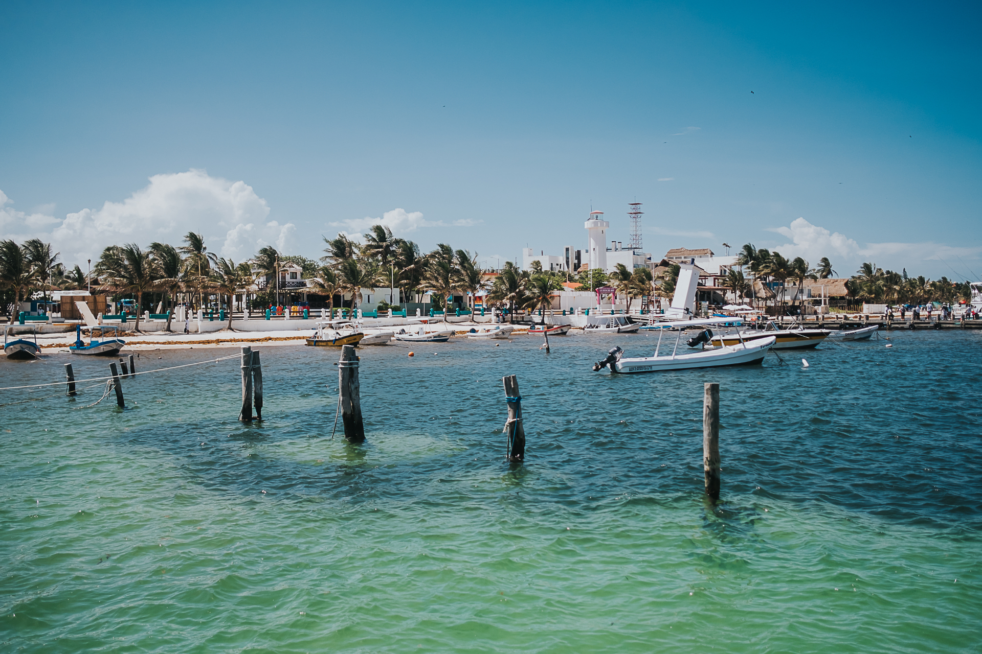 Puerto Morelos harbor with the leaning lighthouse, fishing boats and turquoise Caribbean water